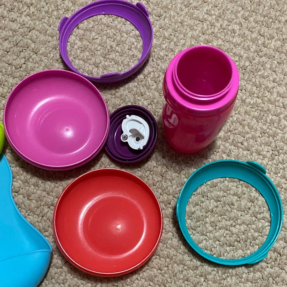 2 bibs, green & blue, 2 suction bowls, pink & purple, 1 tommie tippie sippie cup